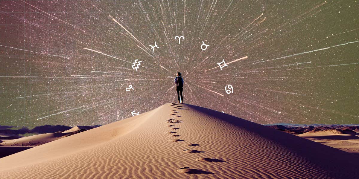 zodiac wheel around person standing on sand dune