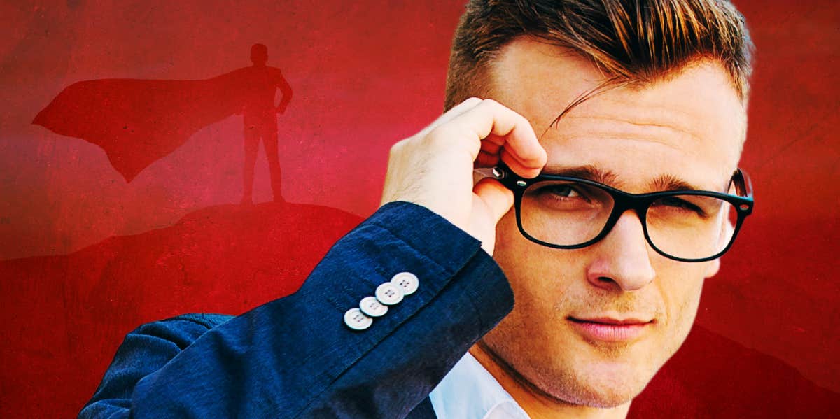 superman-esque man holding glasses