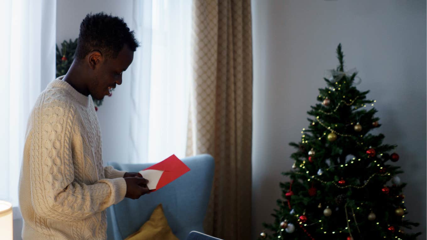man opening letter at Christmas