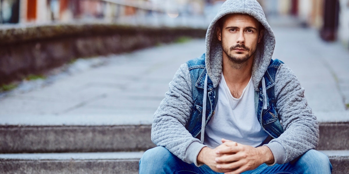 taking a break in a relationship man wearing a hoodie sitting on stairs