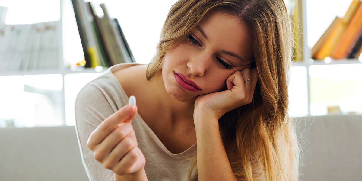 woman taking pill