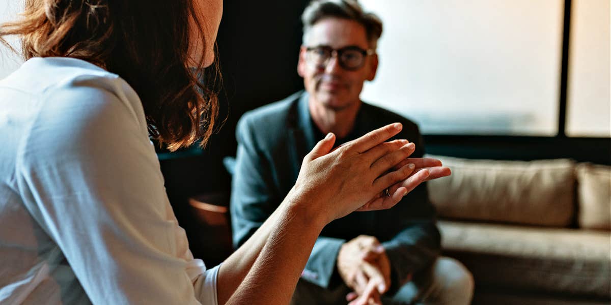 woman talking to therapist in an office with big windows