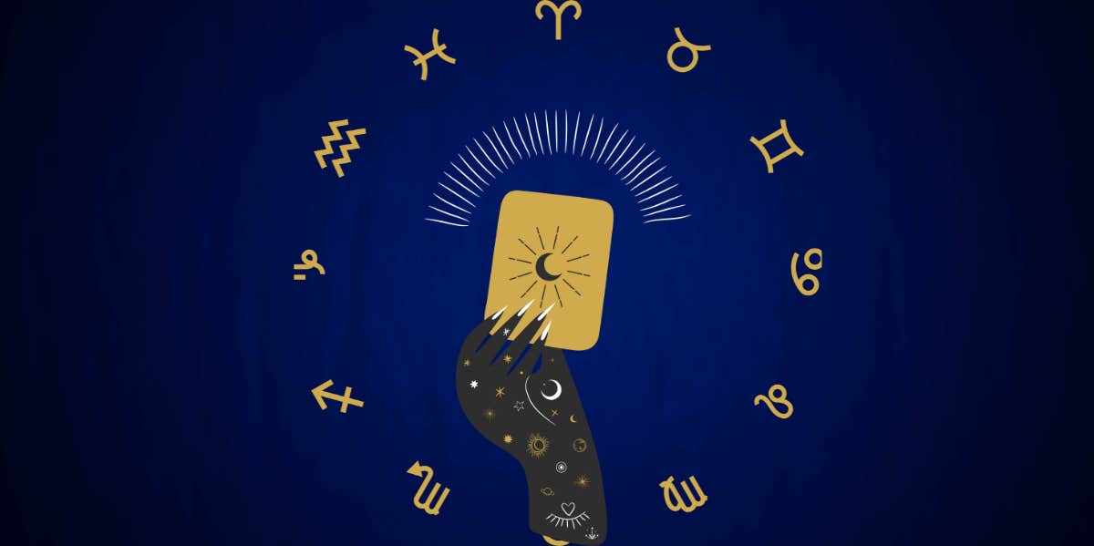 blue background with zodiac wheel and hand holding gold tarot card