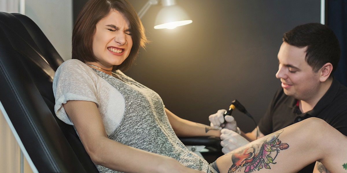 photo of woman getting a tattoo