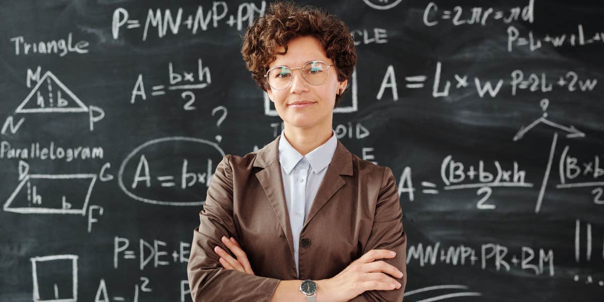Teacher in front of a blackboard in a classroom