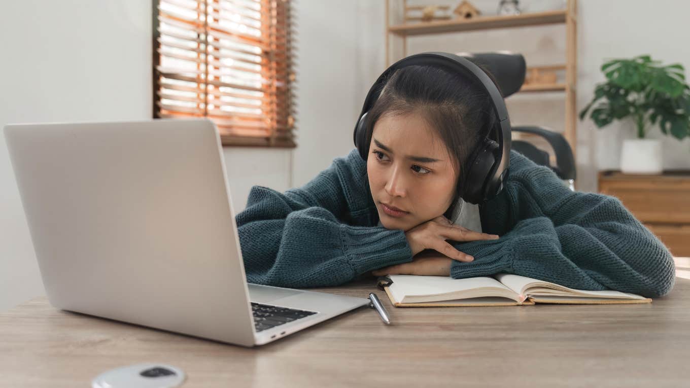Sleepy high school student staring at her laptop. 