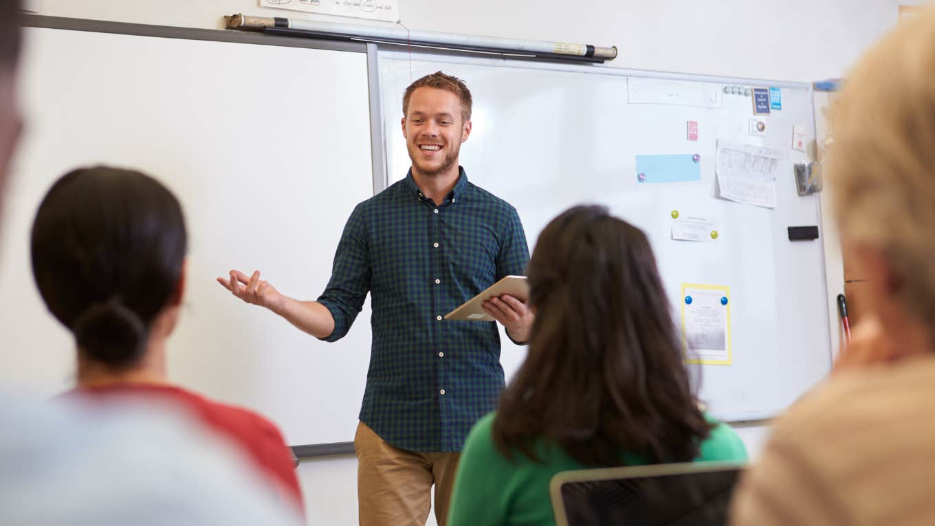 male teacher standing in front of classroom