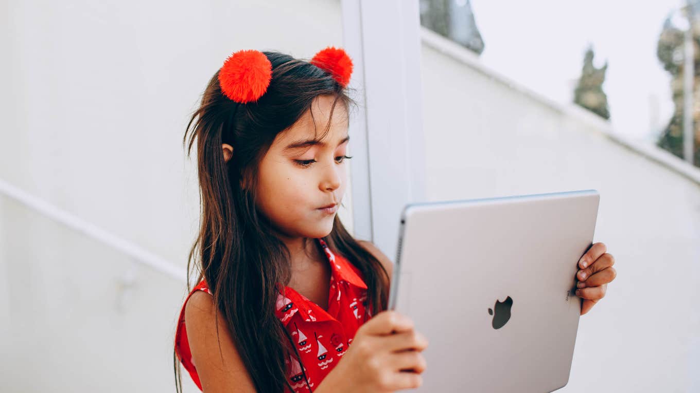 young girl uses ipad