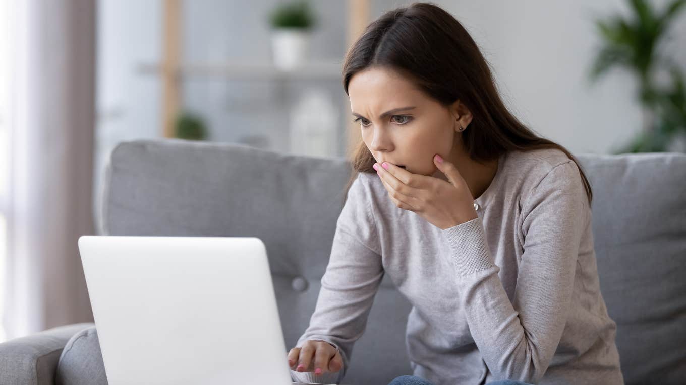 Upset teacher looking at computer