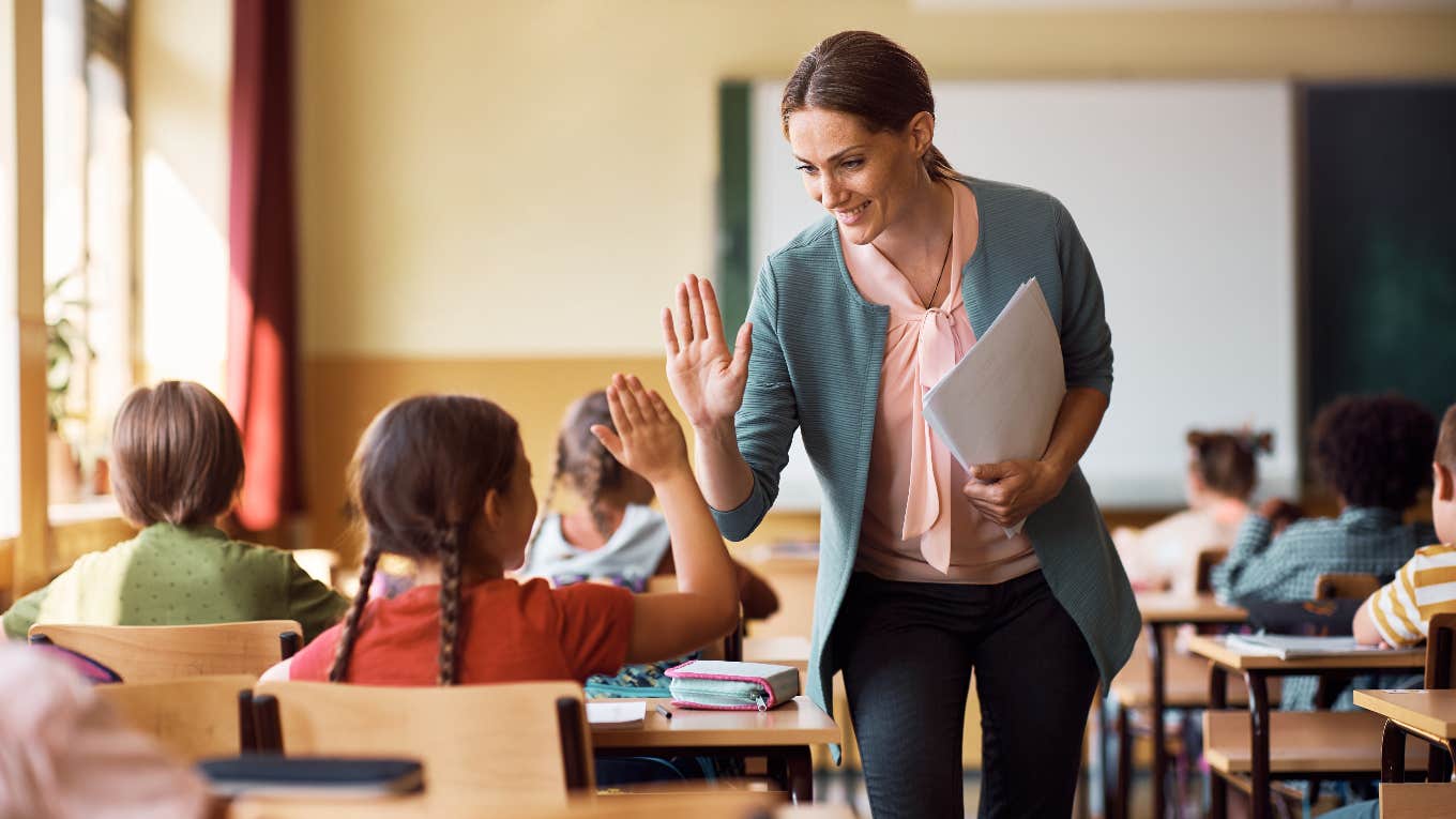 happy teacher in classroom