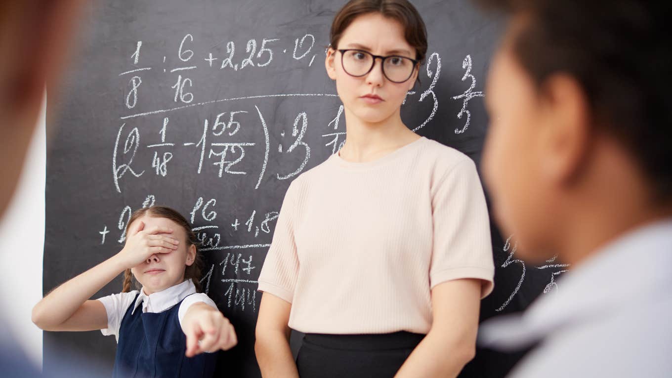 Teacher confronts student while another points a finger at him. 