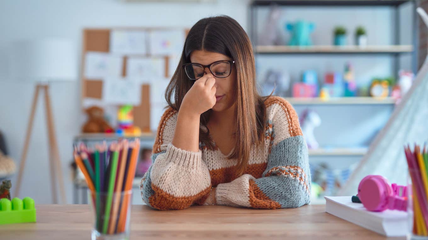 frustrated teacher sitting at her desk