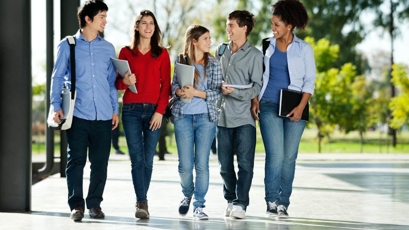Teacher Says We Need To Stop Telling Kids Not To Go To College group of college students walking with backpacks