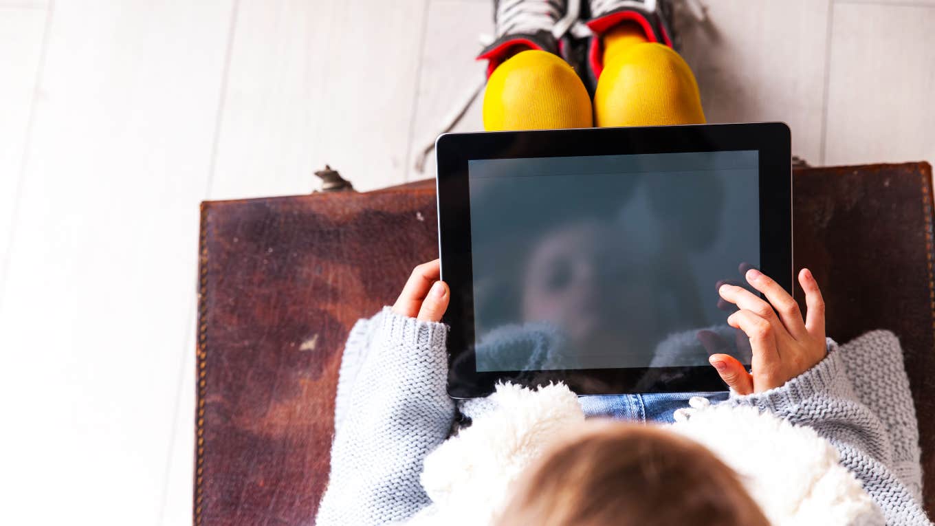 kid sitting down using iPad