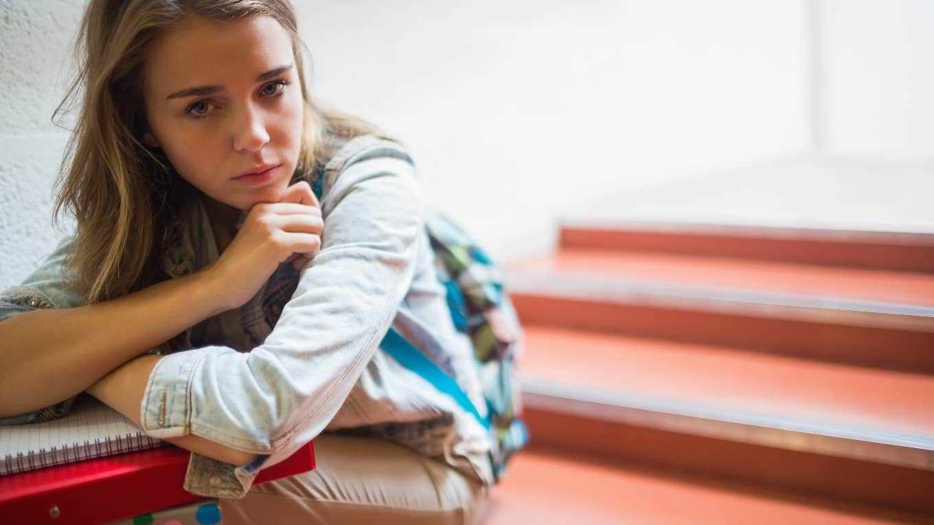 Teacher Told Student They Don't Care About Her Personal Issues upset student sitting in stairwell