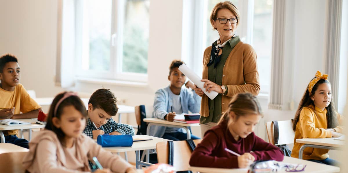 woman teaching classroom of students