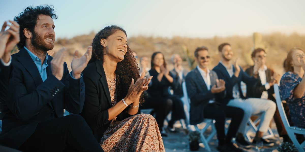 Wedding guest clapping outside