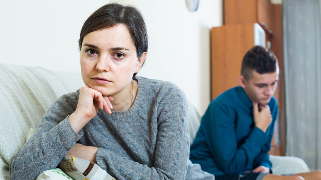 upset mother with mad teen son behind her