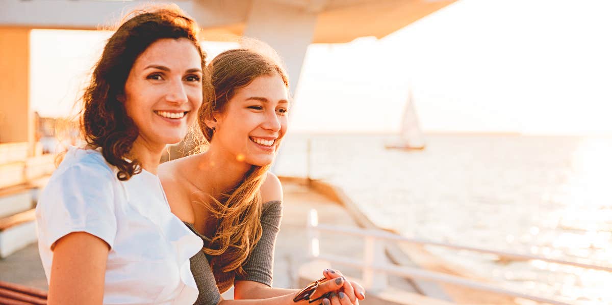 Teenager controlling relationship Mom with teenager looking out over the water