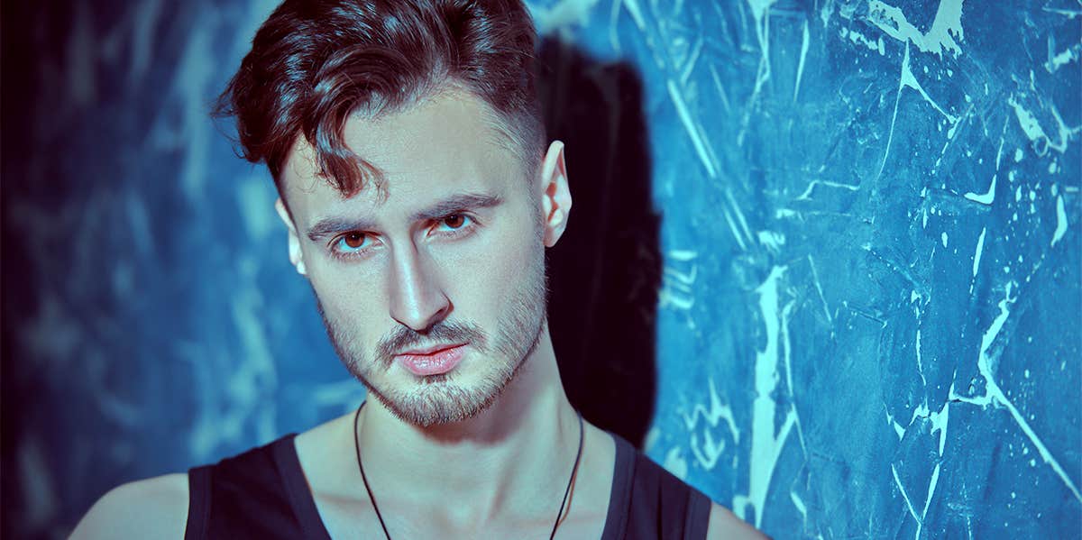 10 Subtle Differences That Separate Men From Boys masculine guy posing near wall