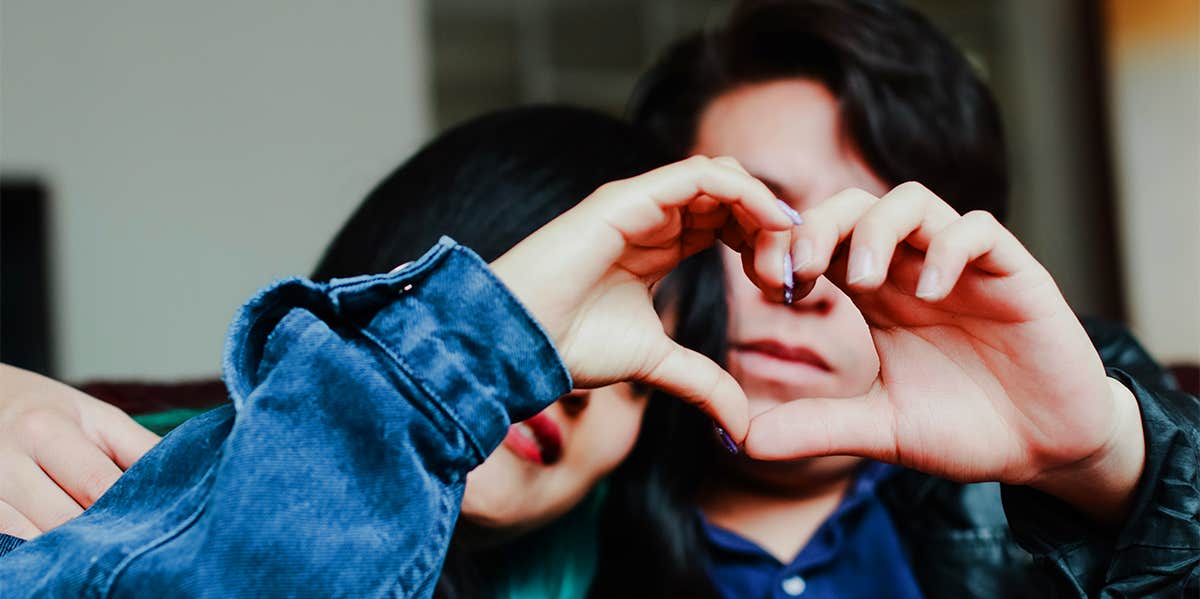 couple making heart shape with their hands