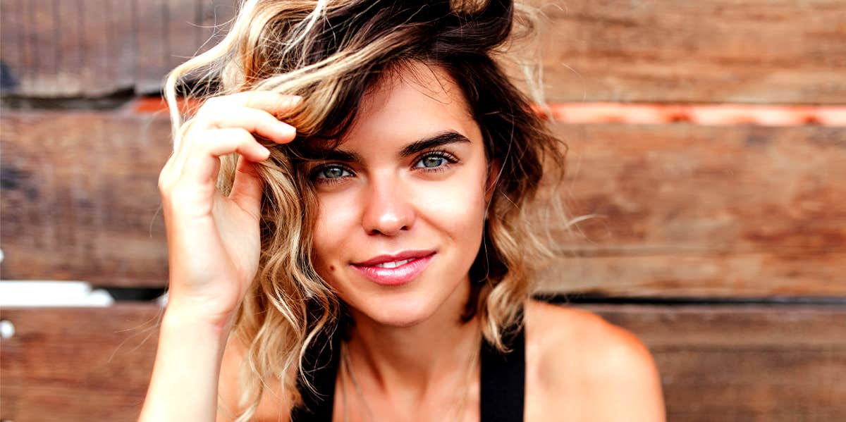 Rare Signs You're An Ambivert (Half Introvert, Half Extrovert) smiling woman