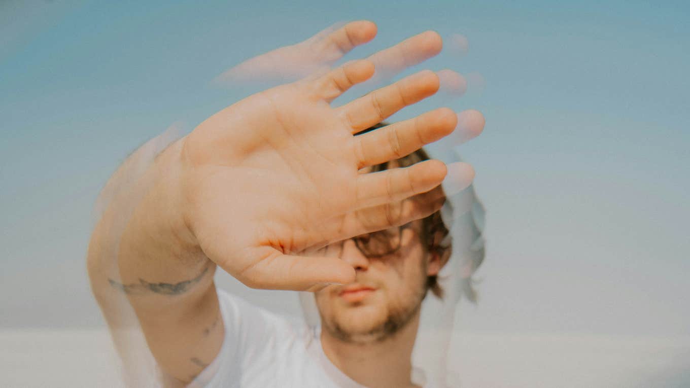 Man blurred with his hand up artistic 