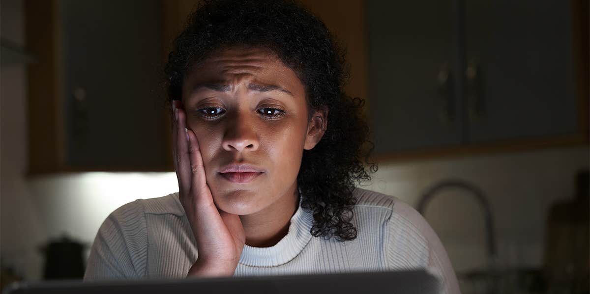 woman shocked looking at computer