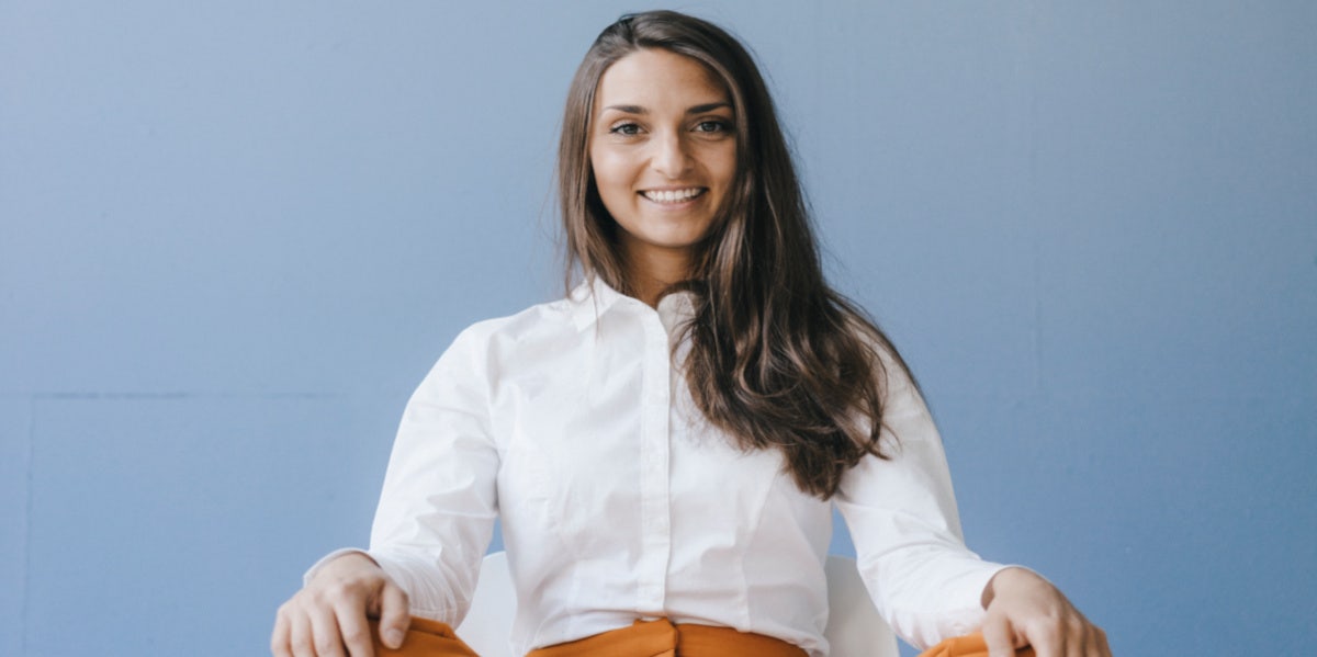 woman sitting with hands on knees 