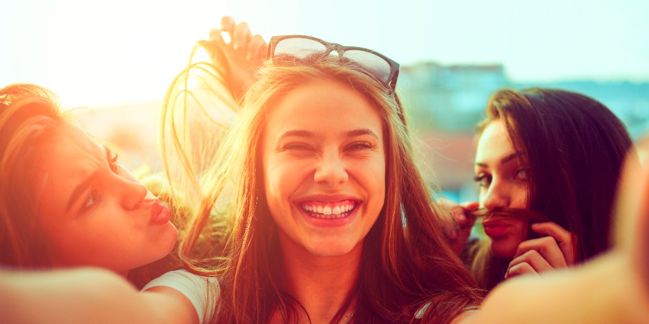 single woman taking selfie and smiling