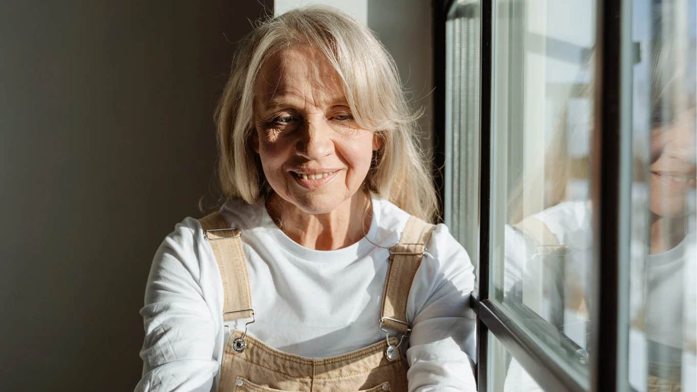 older woman sitting by a window