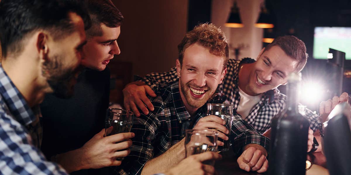 The Critical Difference Between "Men" And "Guys" group of guys at bar