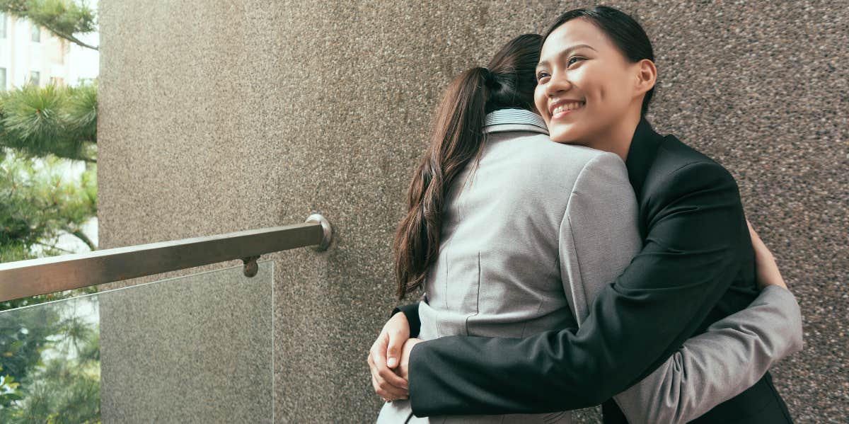 Intern Who Won't Stop Hugging People At Work Gets Fired woman hugging another woman
