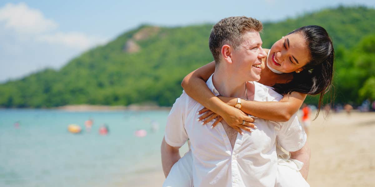 Where You're Most Likely To Meet Your Future Spouse, According To Research couple at the beach