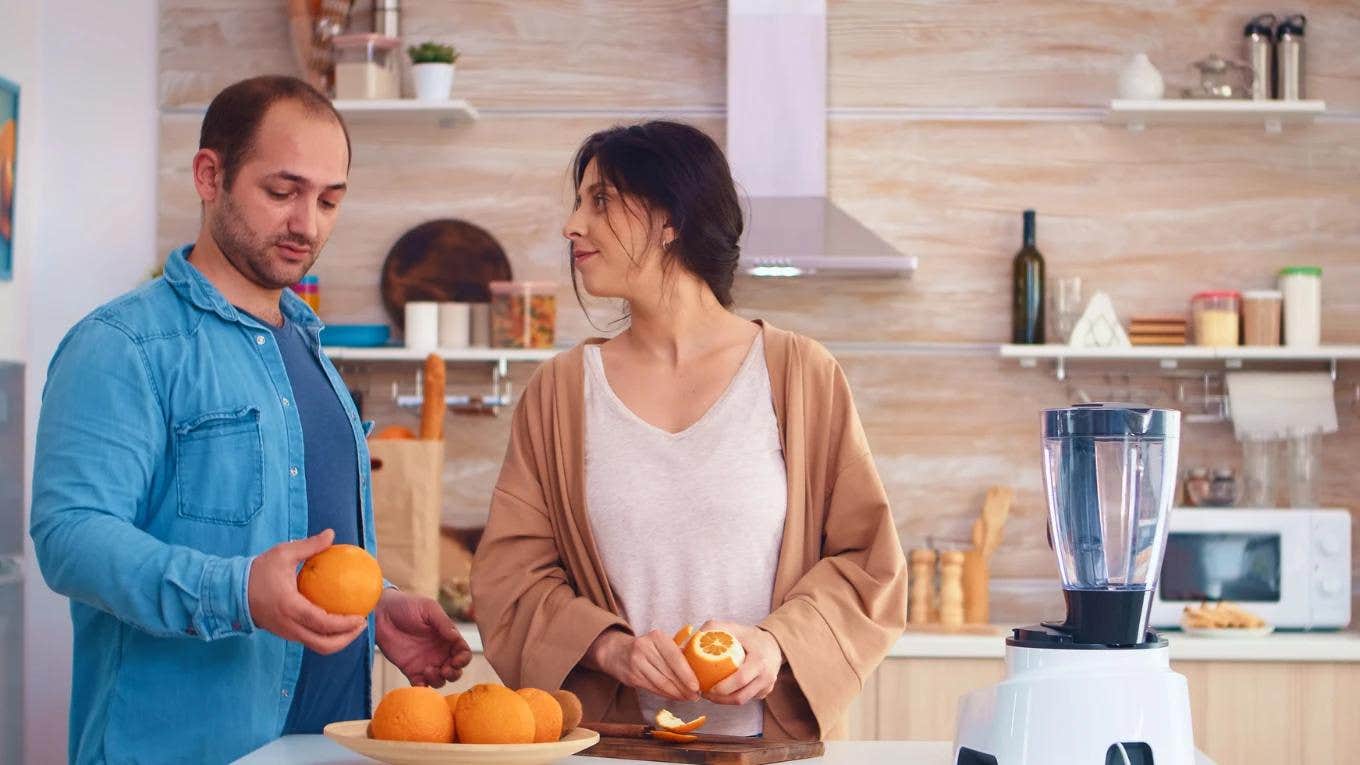 The Orange Peel Theory Can Tell You The Longevity Of Your Relationship woman peeling an orange for her partner
