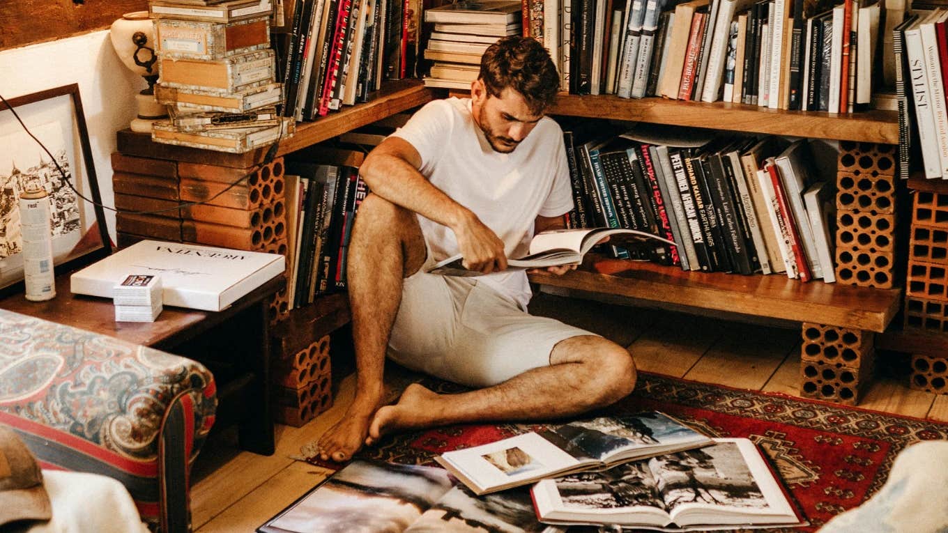 The Reason Why Men Don't Read Fun Books man reading surrounded by books