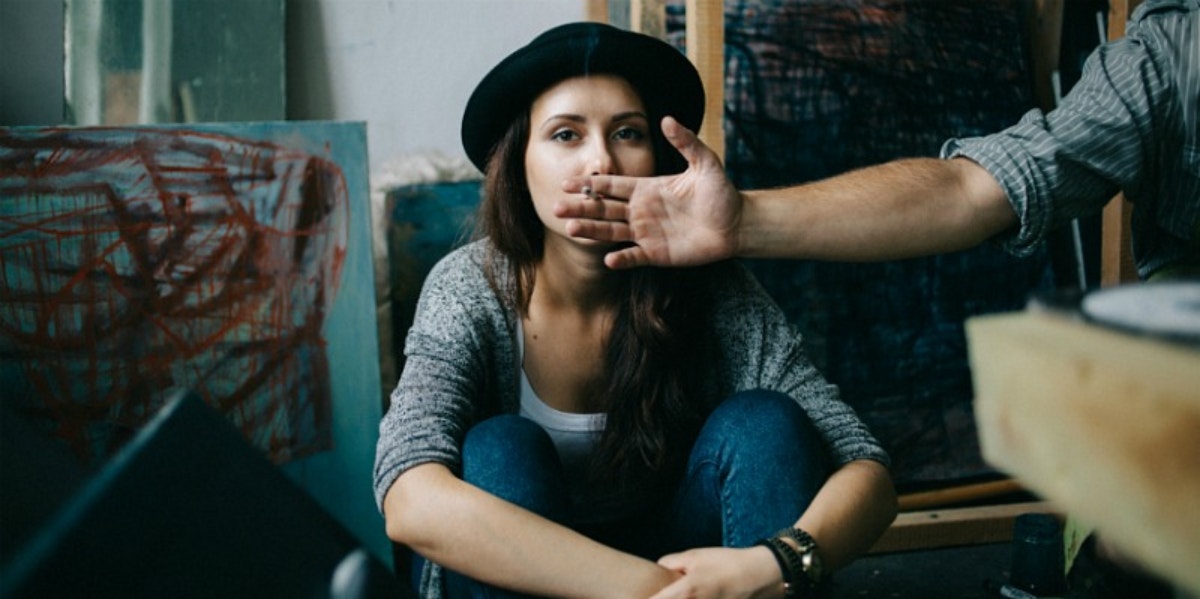 man holding out cigarette woman smoking it