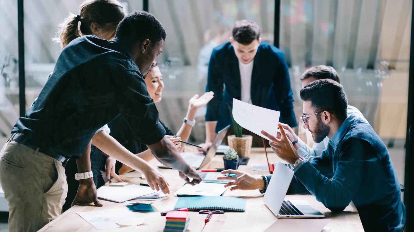 The One Toxic Phrase That If You Hear At Work Should Be A Sign To Quit Immediately employees brainstorming during a meeting in an office