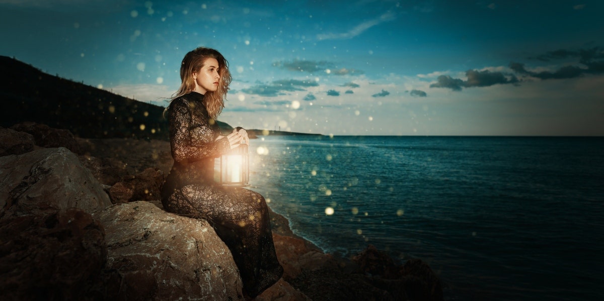 woman by the water at night