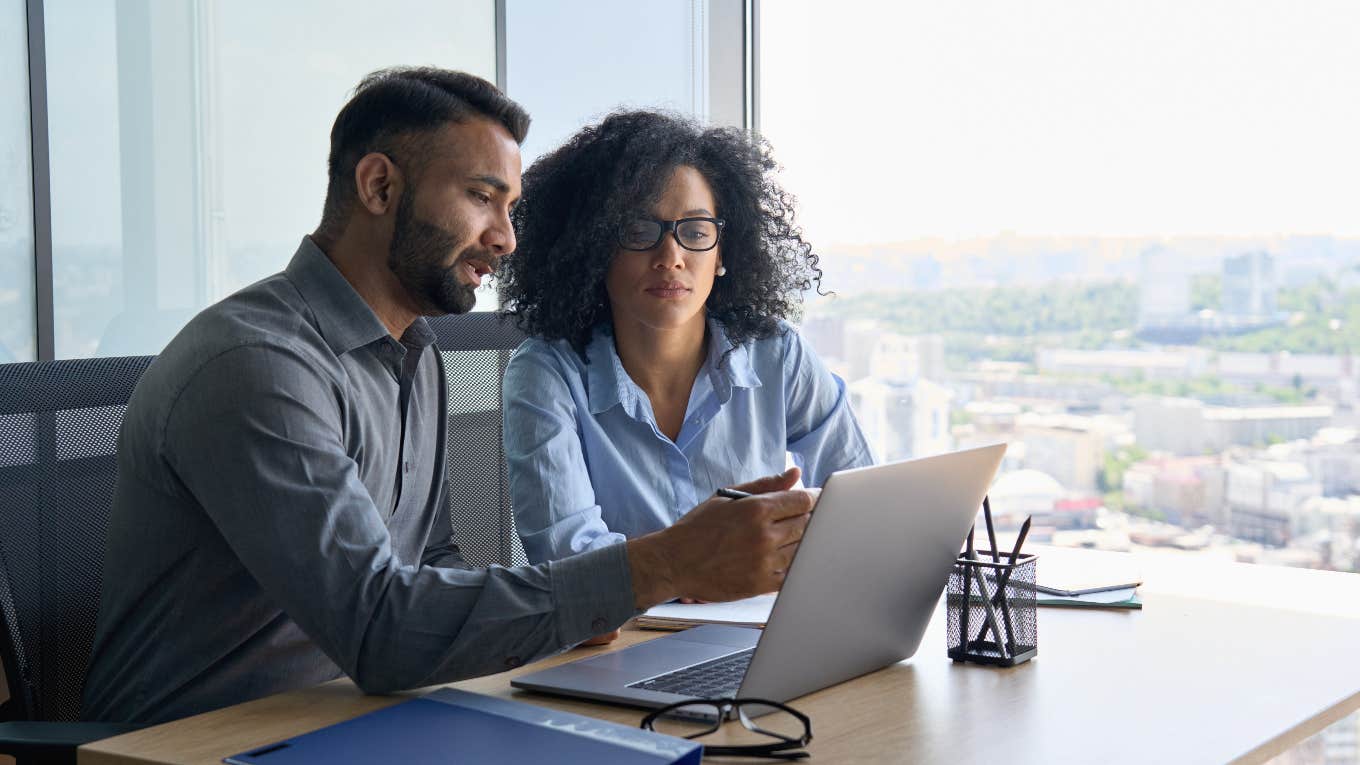 boss and employee looking at computer