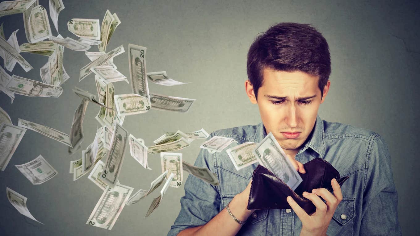 People Share Theories On Why It's Gotten So Expensive To Be Poor man pulling money out of his wallet