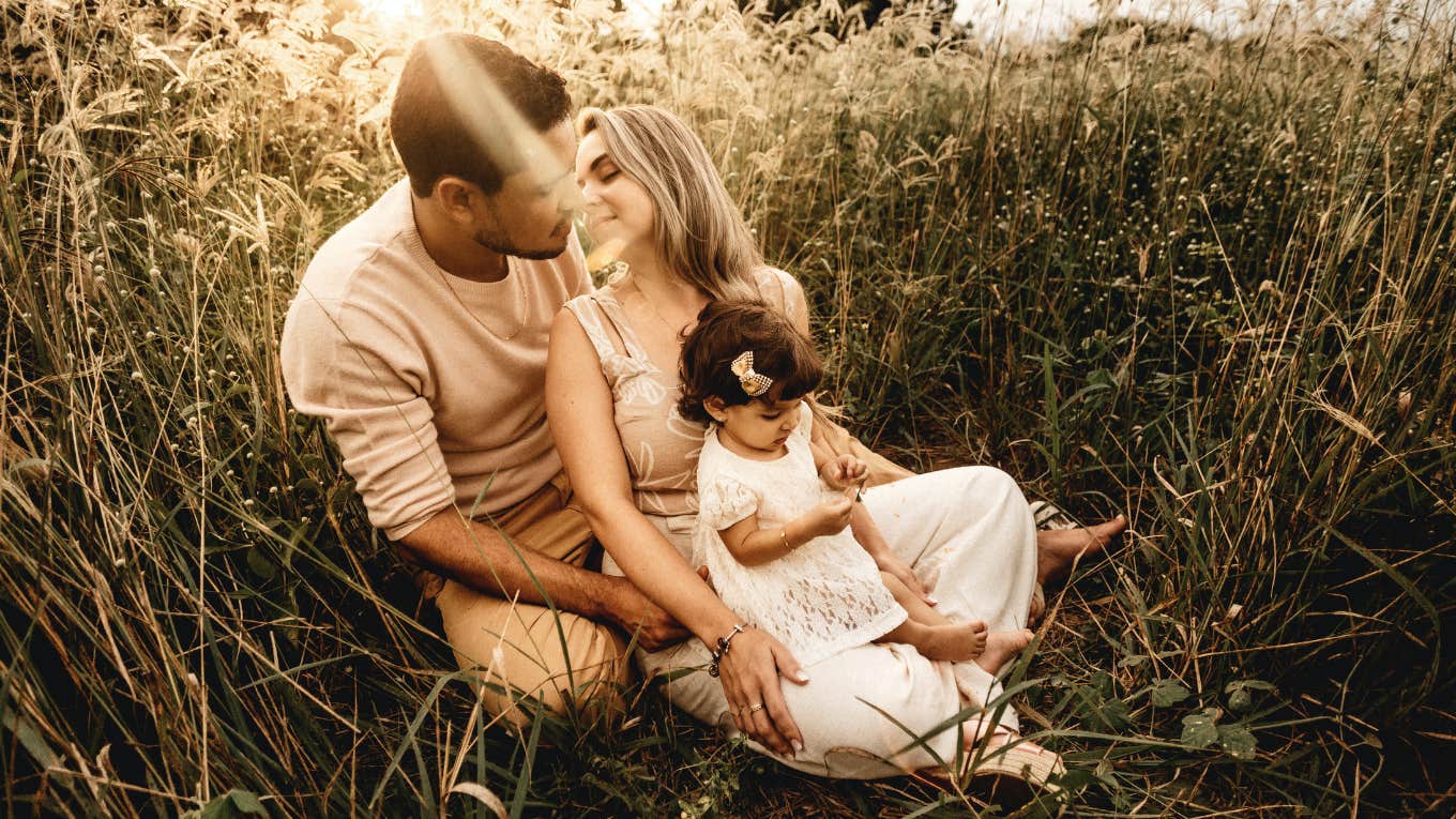 family sitting in a field