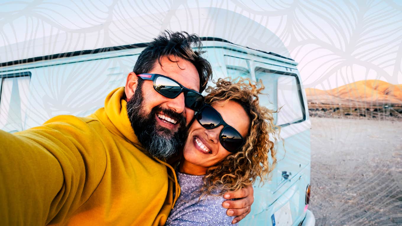 Couple taking a selfie in front off their van