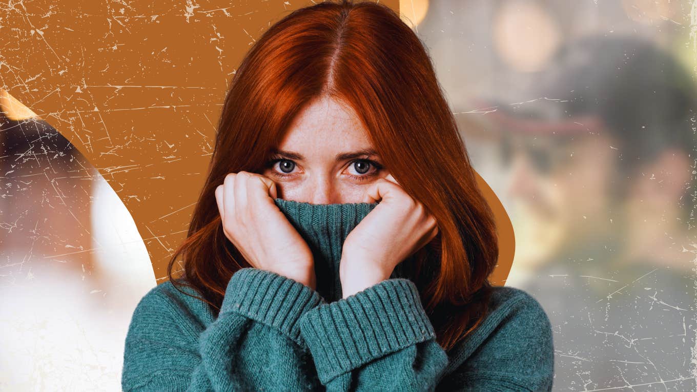 Woman pulling sweater over nose only showing eyes 