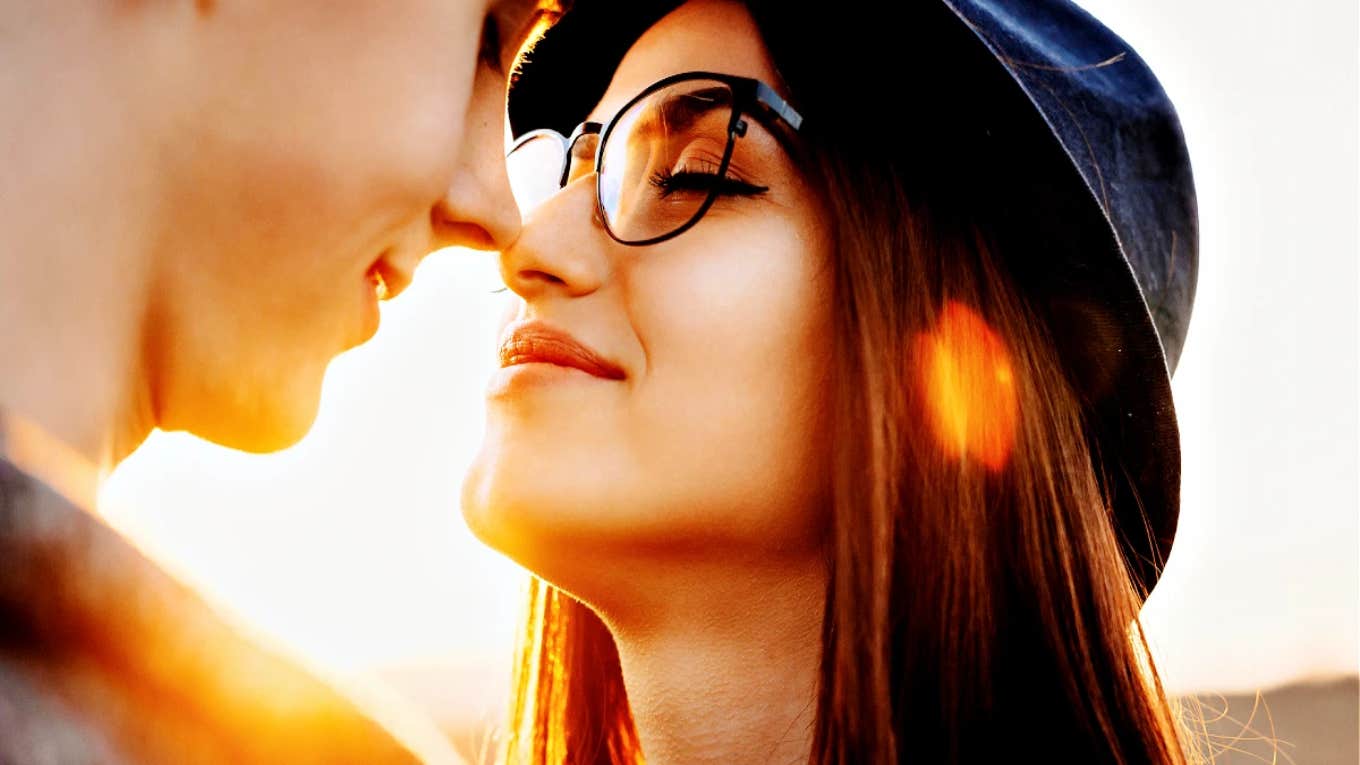 4 Things Couples In Healthy, Secure Relationships Do Differently couple smiling about to kiss