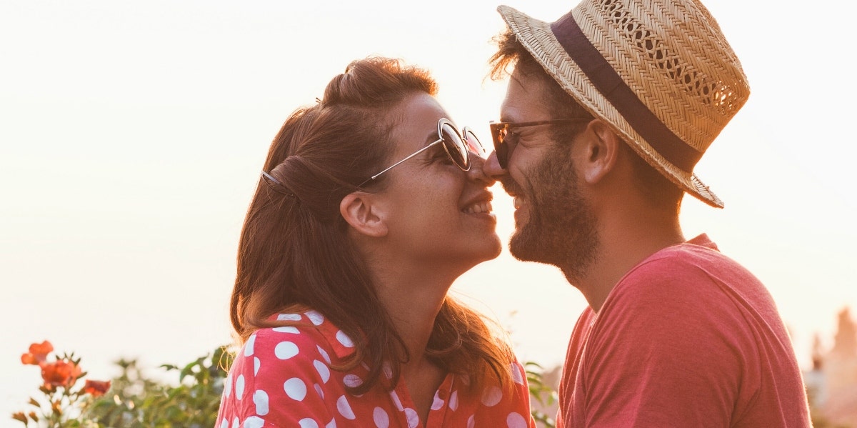 man and woman kissing outside