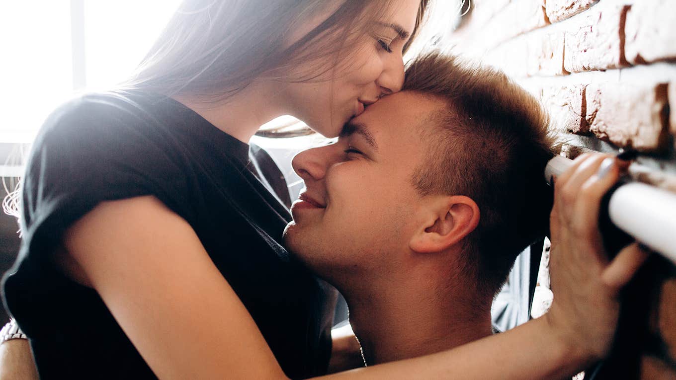 couple in love embracing and sitting on the bed