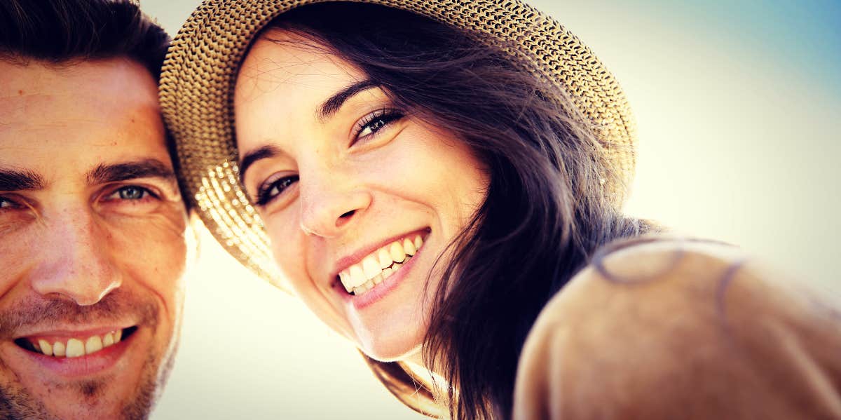 phrases that damage relationships woman and man smiling against the blue sky