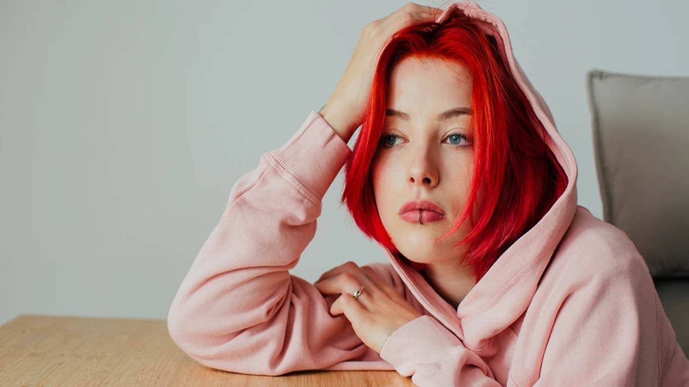 10 Things People With Emotional Wounds Do Without Realizing sad woman with red hair thinking