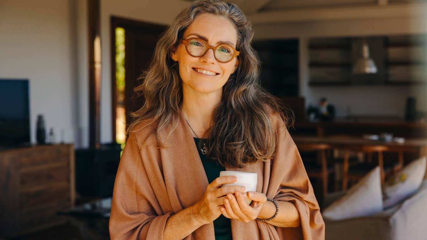 smiling woman holding coffee cup